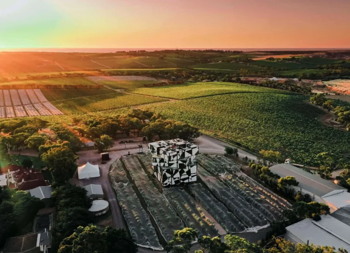 Aerial view of the d'Arenberg Cube among McLaren Vale wineries at sunset
